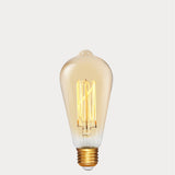 Dulora 4W Edison Vintage LED Bulb E27 in Ultra Warm White glowing deep amber through vintage ST64 glass