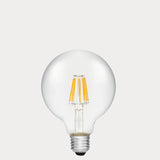 Dulora 8W E27 LED globe bulb in clear glass with AC/DC compatibility, shown unlit.